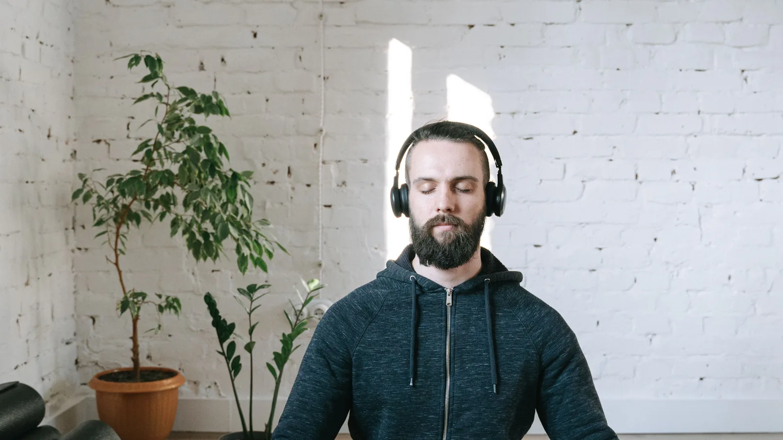 Listener using headphones in a quiet setting to evaluate calm background music
