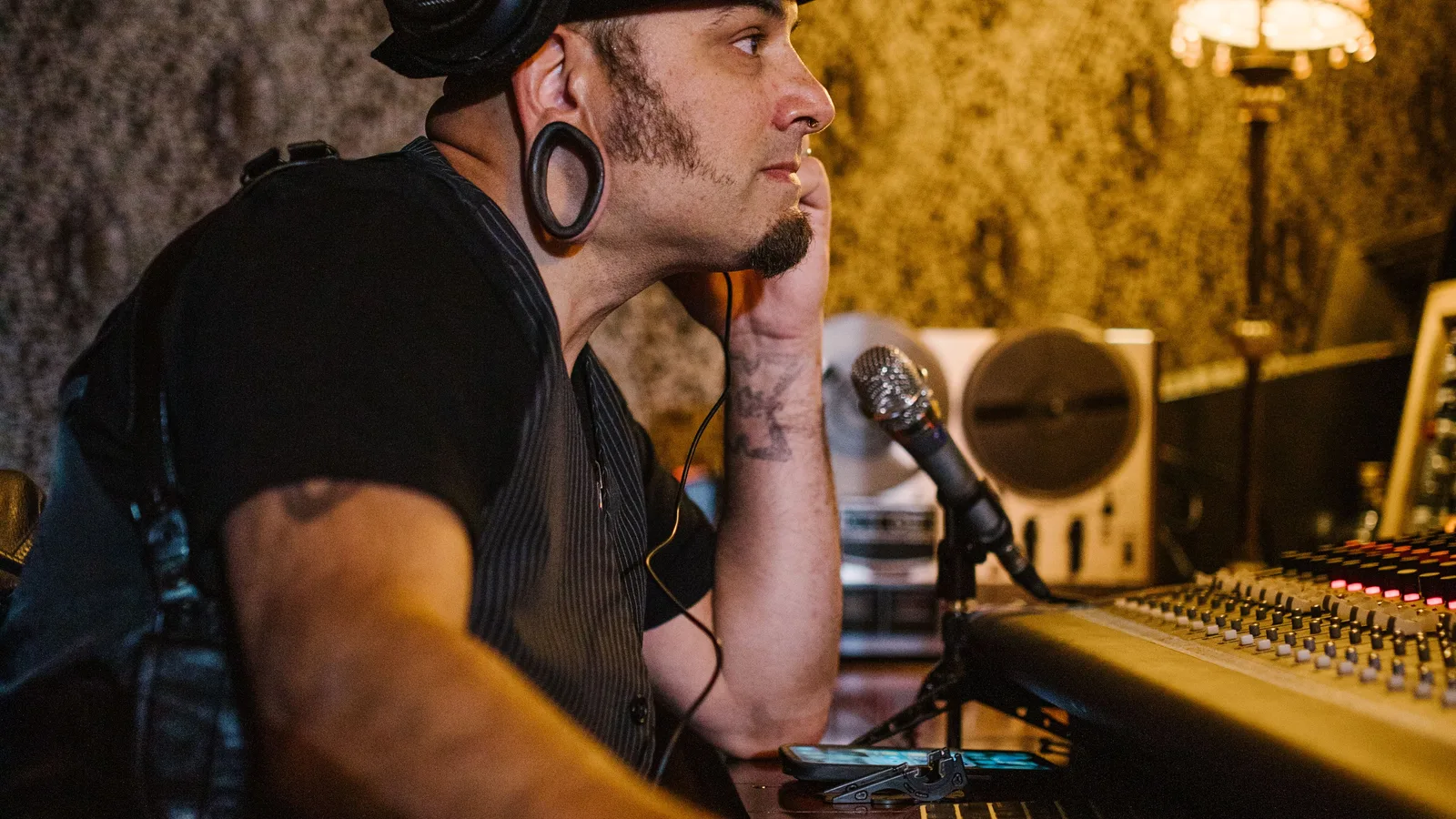 Music producer checking the balance and energy of a background track in a studio