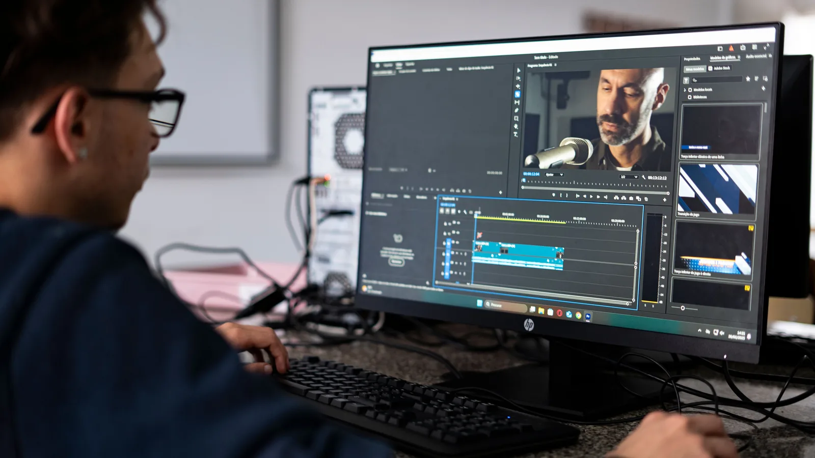 Video editor arranging picture and audio tracks on a desktop editing timeline